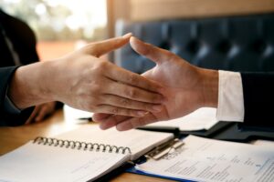job seeker and interviewer shaking hands to signify job search success