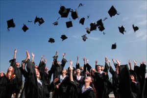 Fresh graduates throwing their caps in the air