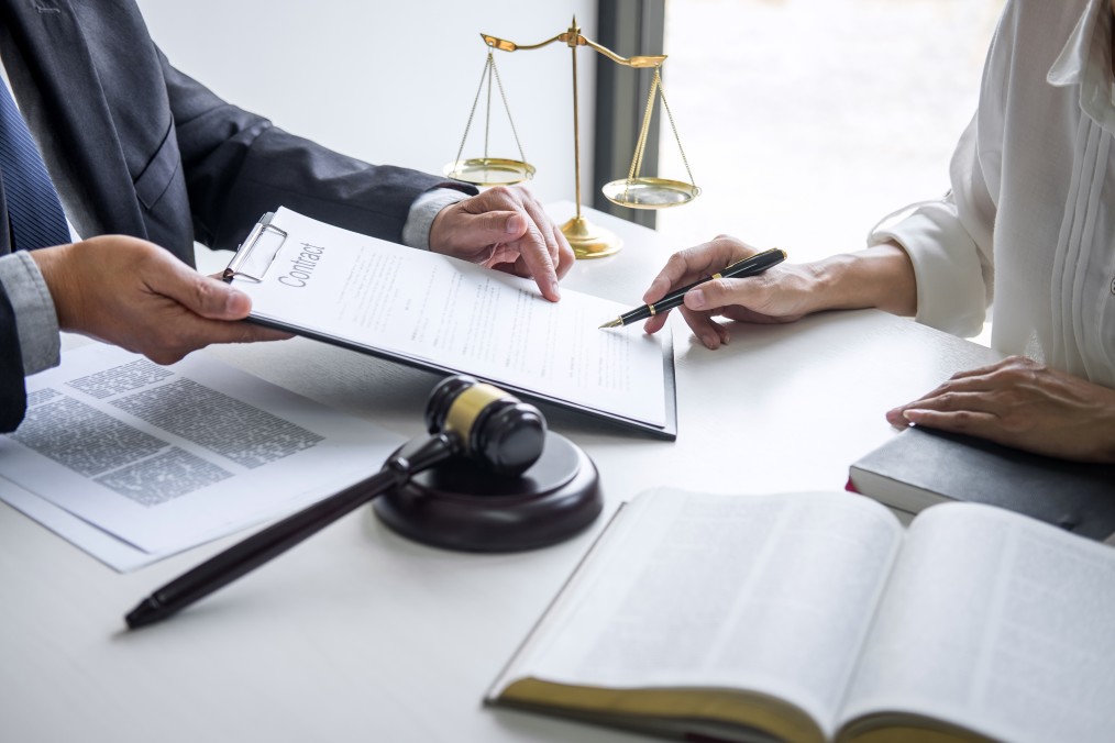 A Paralegal Talking To A Lawyer Regarding Contract