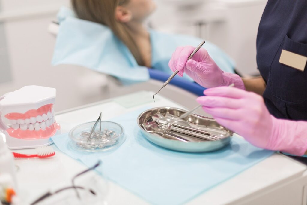 Dental Assistant Taking Dental Instruments