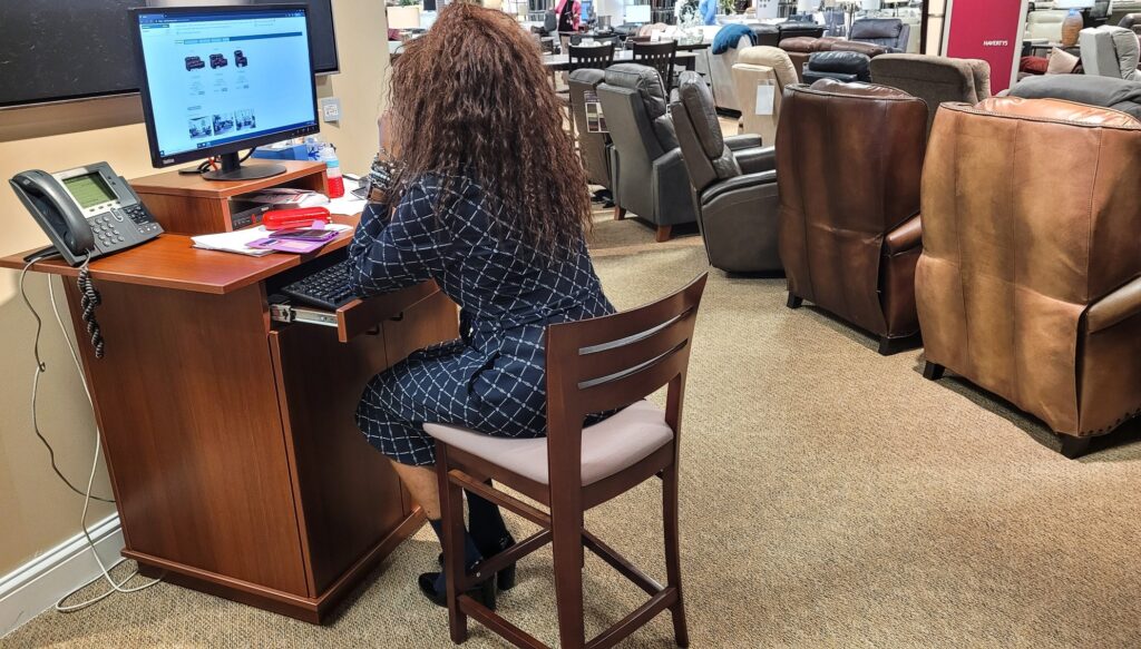 Sales Associate Working On Website Sales Of Their Furniture