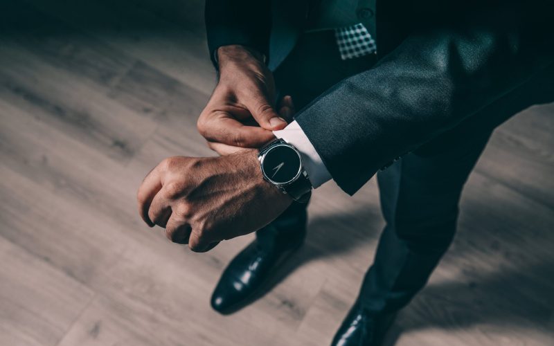 Signs of an effective leadersship is when one comes on time as signified by a man wearing a suit fixes his watch