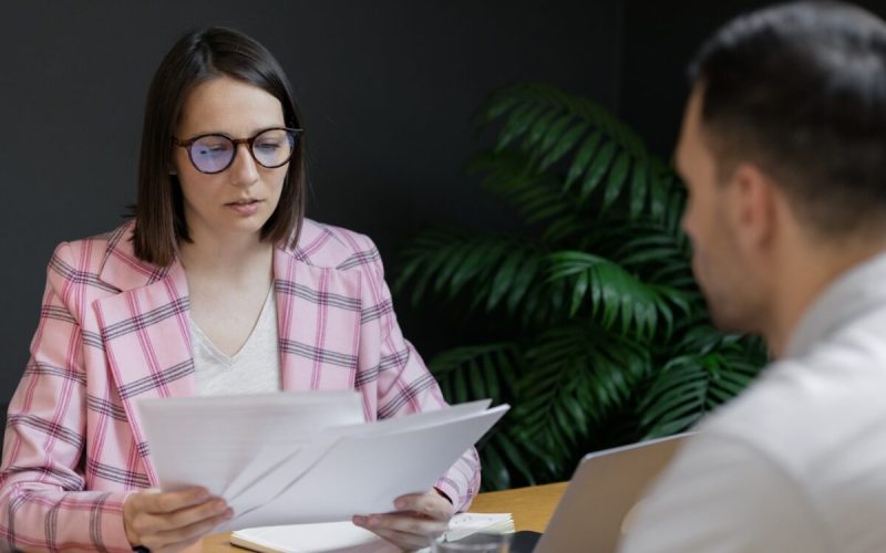 hiring manager reviewing candidate's resume during interview