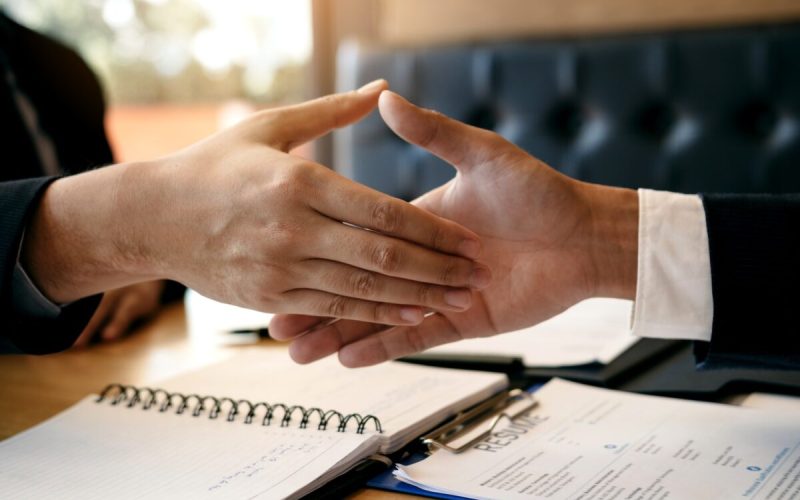 job seeker and interviewer shaking hands to signify job search success
