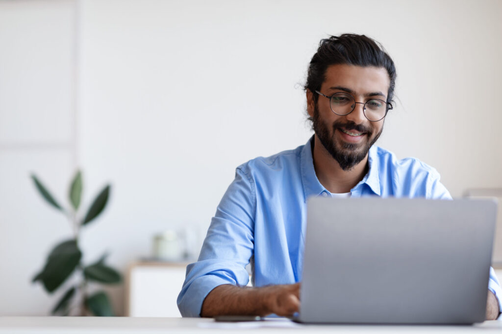A Man Smiling To Job Search Using Specialized Resume