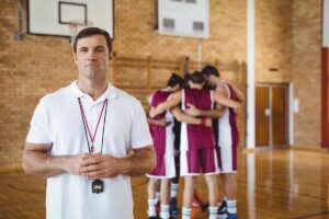 Focused Basketball Coach Leading A Dynamic Practice Session