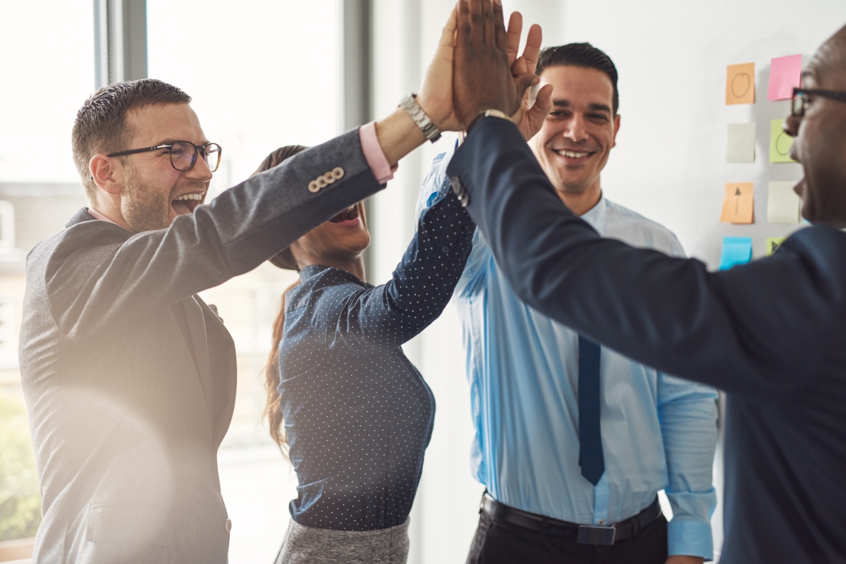 New Employees Celebrating In Their New Jobs After Getting Hired By Using The Right Questions To Ask In An Interview