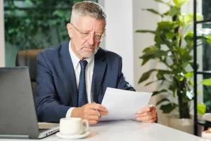 employer evaluating an executive resume in his office
