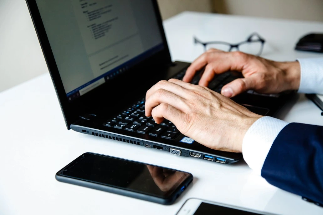 executive resume writer typing in a laptop