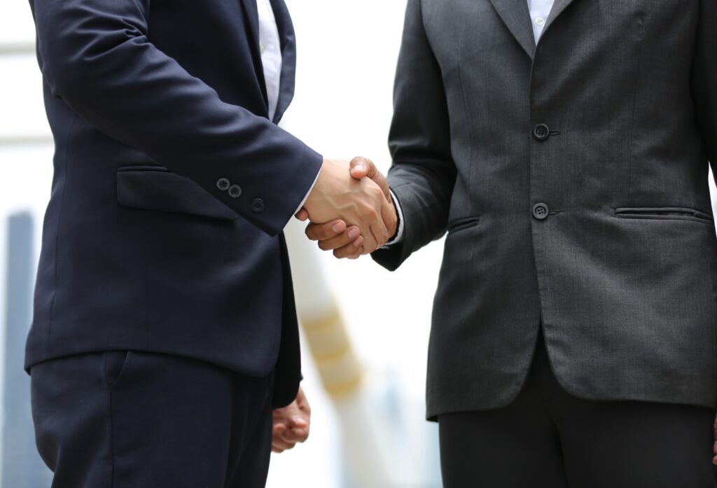 Handshake Of Two Men In Business Suits