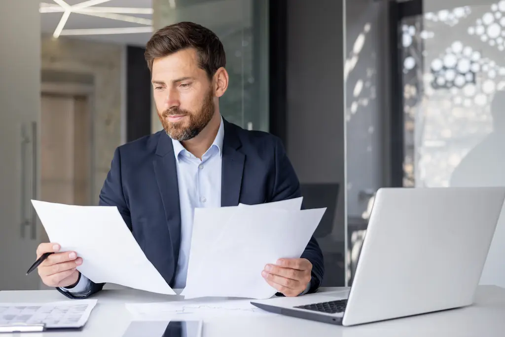 Hiring Manager Reviewing Resume Of Applicants