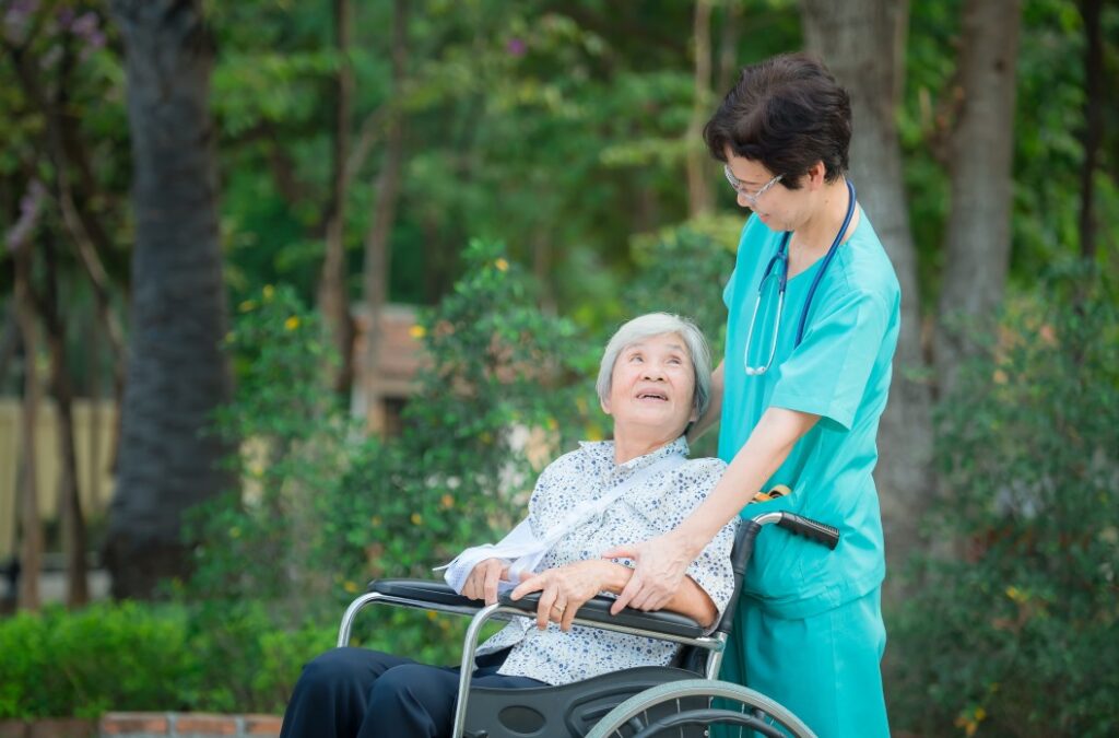 A Cna Taking Care Of A Senior Patient Sitting On A Wheelchair