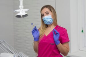 A Dental Assistant Holding Two Dental Tools