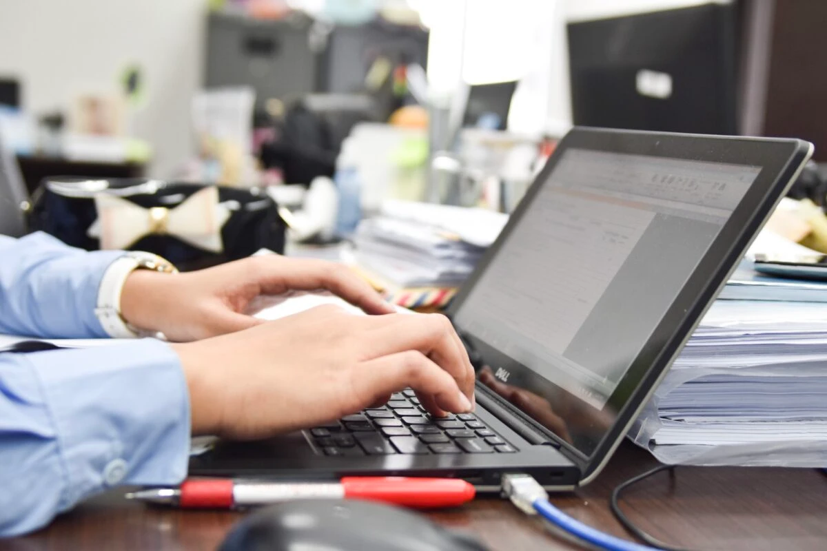 job applicant writing a cover letter on his laptop