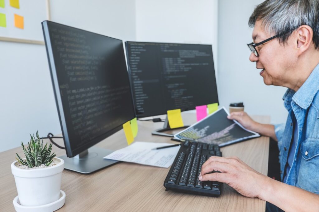 A Senior Software Engineer Reviewing And Debugging Codes