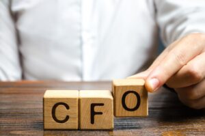 An Individual Holding Cfo Letters Of Wooden Blocks