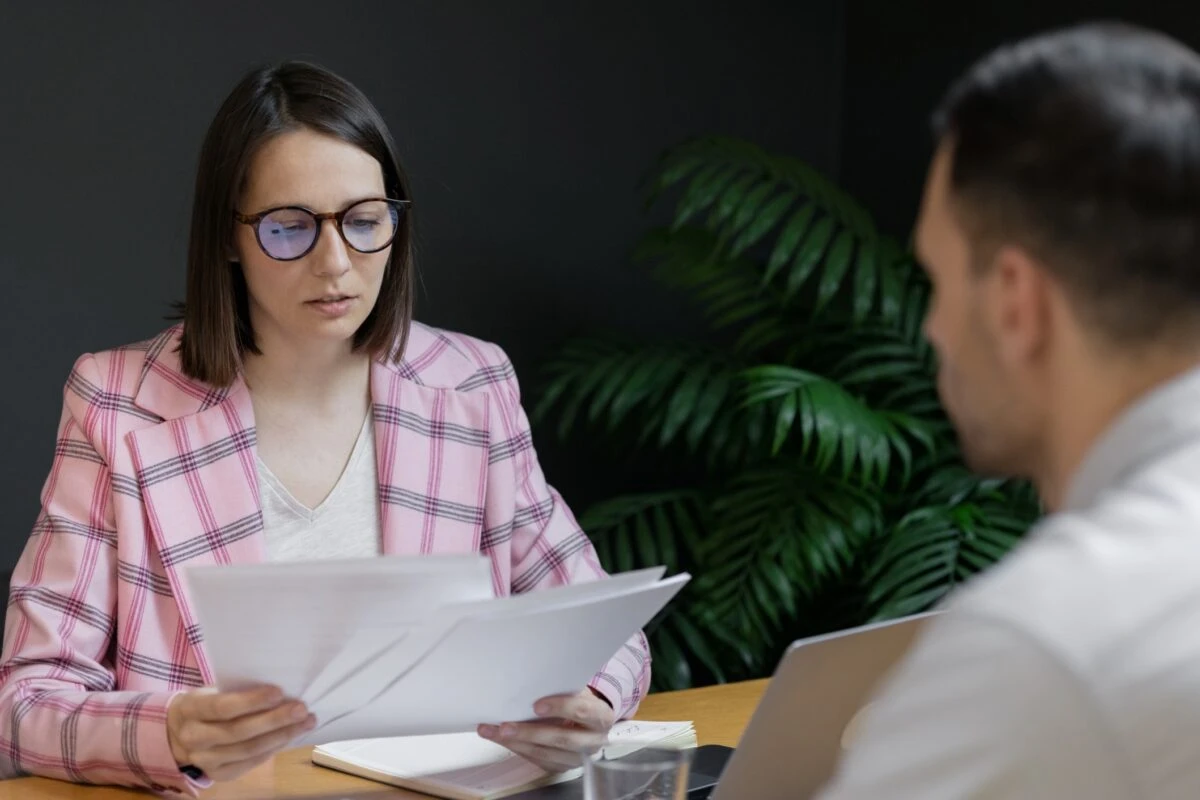 hiring manager reviewing candidates resume during interview