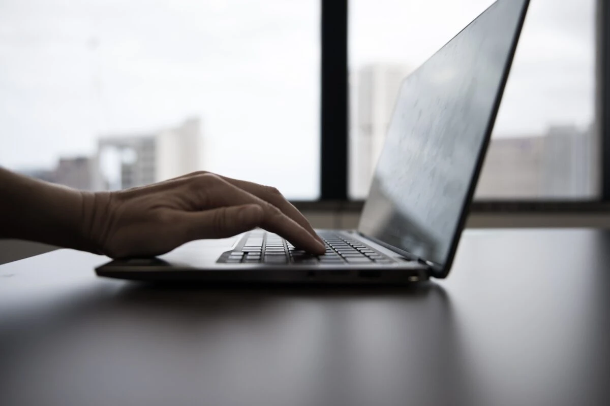 job seeker updating their resume on their laptop