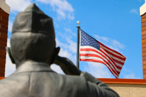 statue of a soldier saluting the American flag