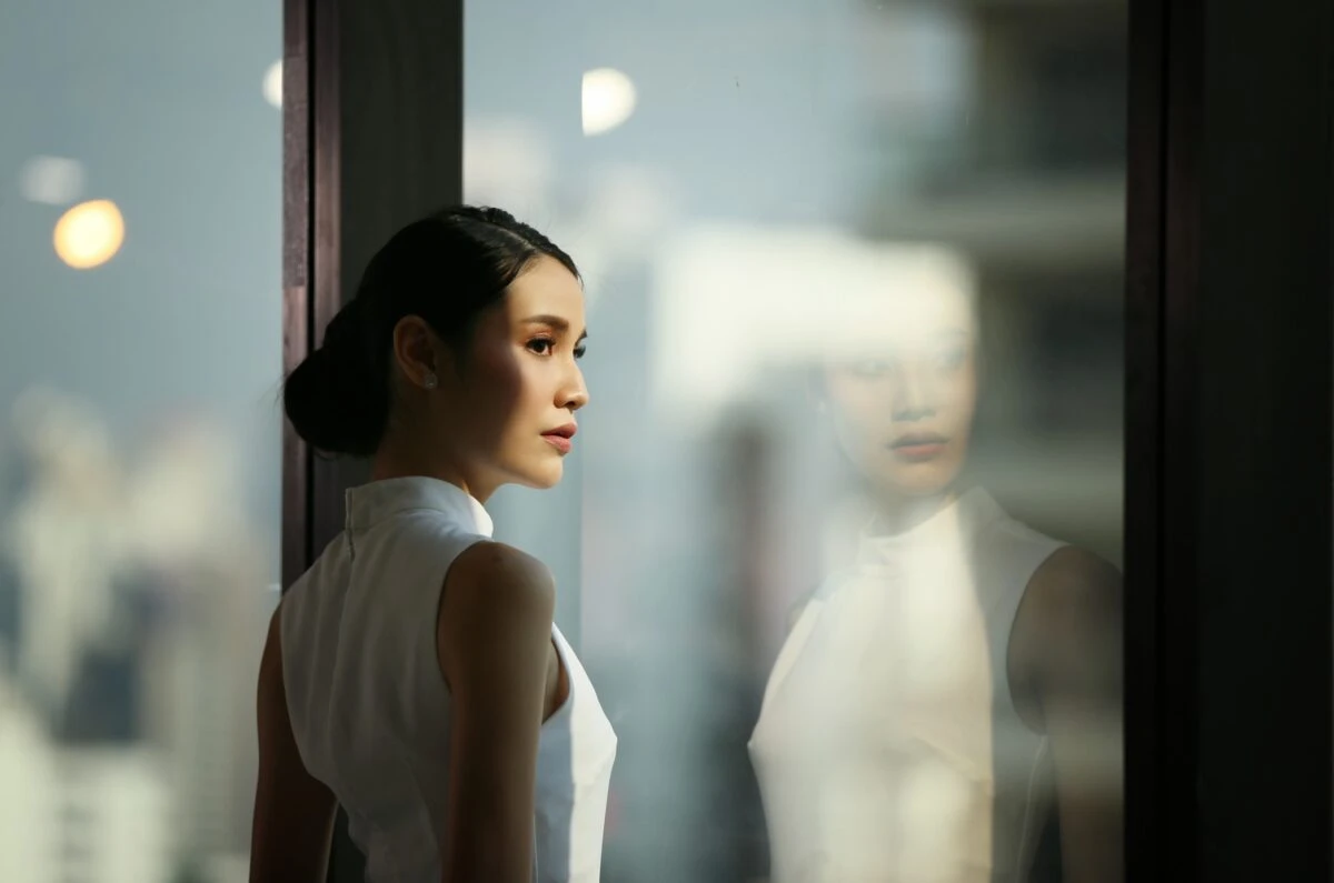 young professional looking at glass window