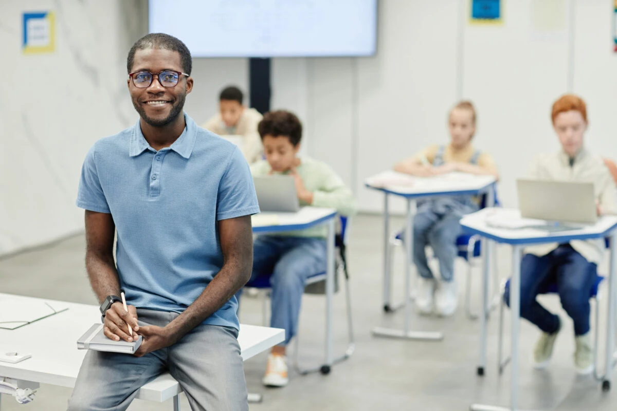 smiling teacher in school classroom