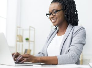 Woman writing an email and know how to respond to an interview request