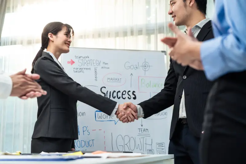 Business Professionals Shaking Hands Roi Analysis