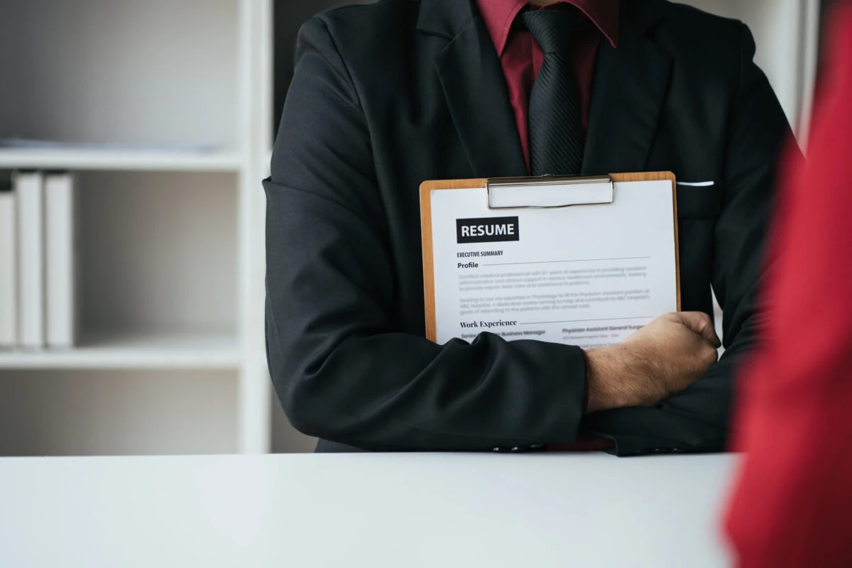 close up view of applicant presenting his resume