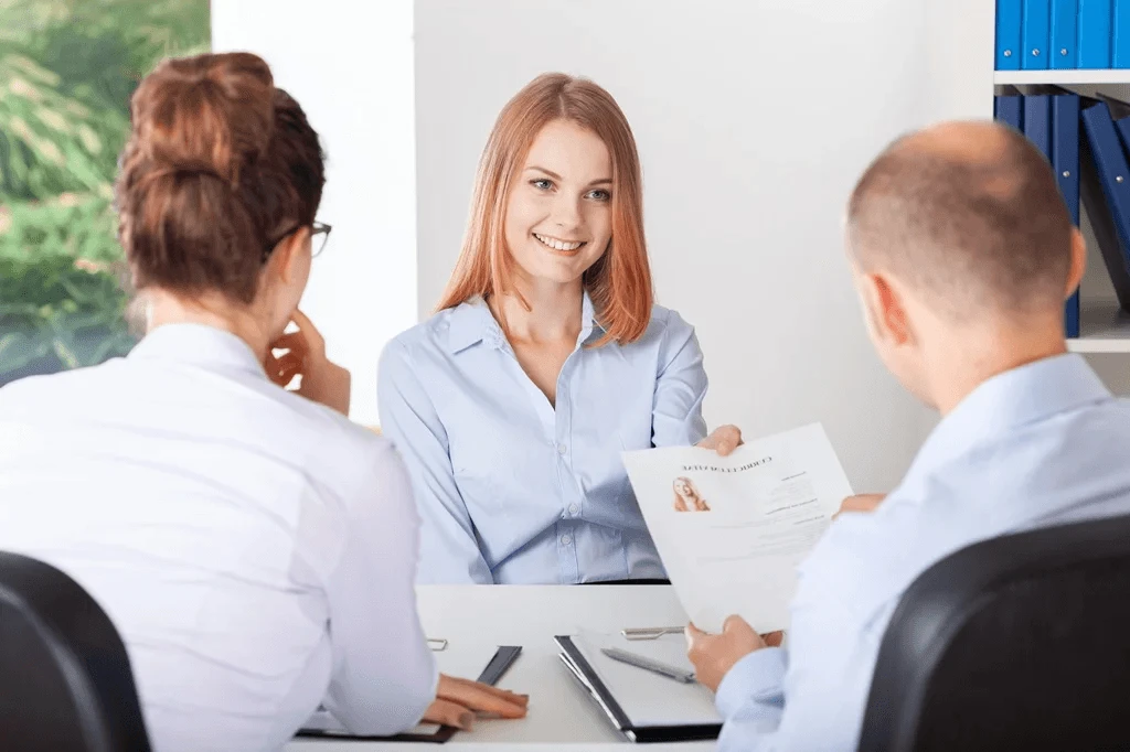 confident applicant showing her resume objective statement in an interview