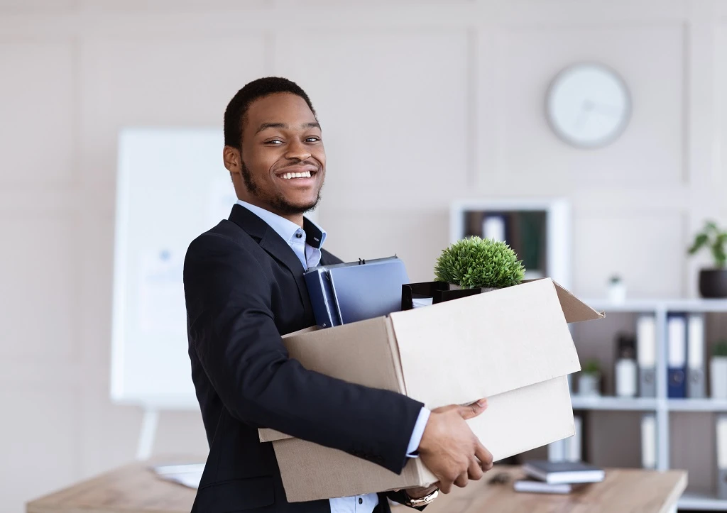 a career changer gathers personal items into a box embarking on a new professional journey