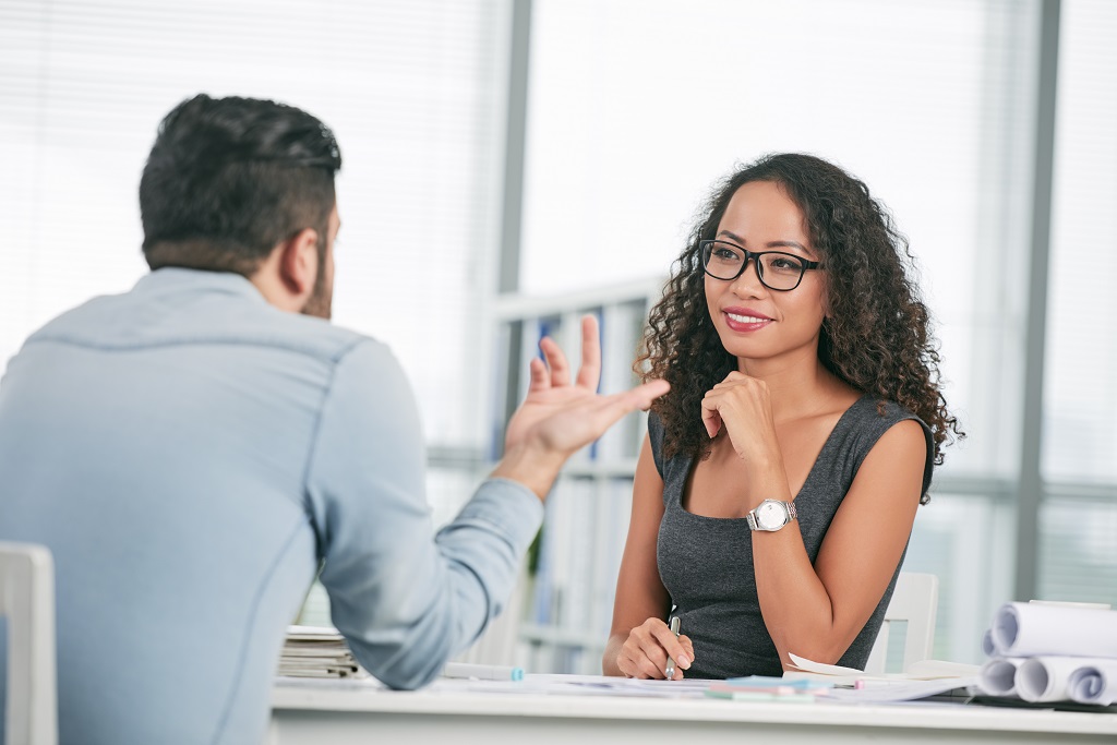 Hiring Manager Attentively Listening To An Applicant During An Interview