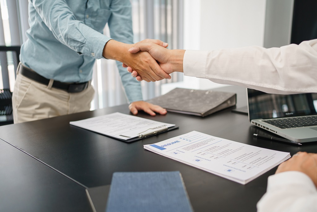 A Candidate Shaking Hands With The Employer And Accepting A Job Offer