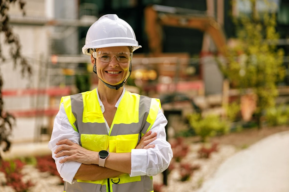 a construction worker standing confidently with arms crossed