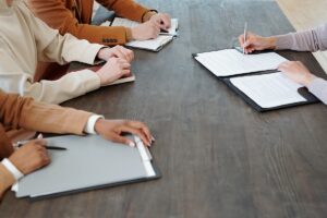 a job seeker confidently signing a contract after learning how to accept a job offer