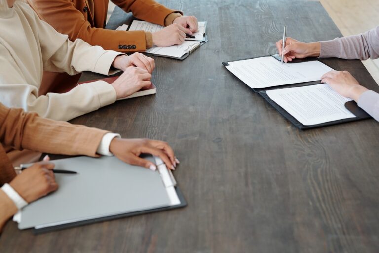 a job seeker confidently signing a contract after learning how to accept a job offer
