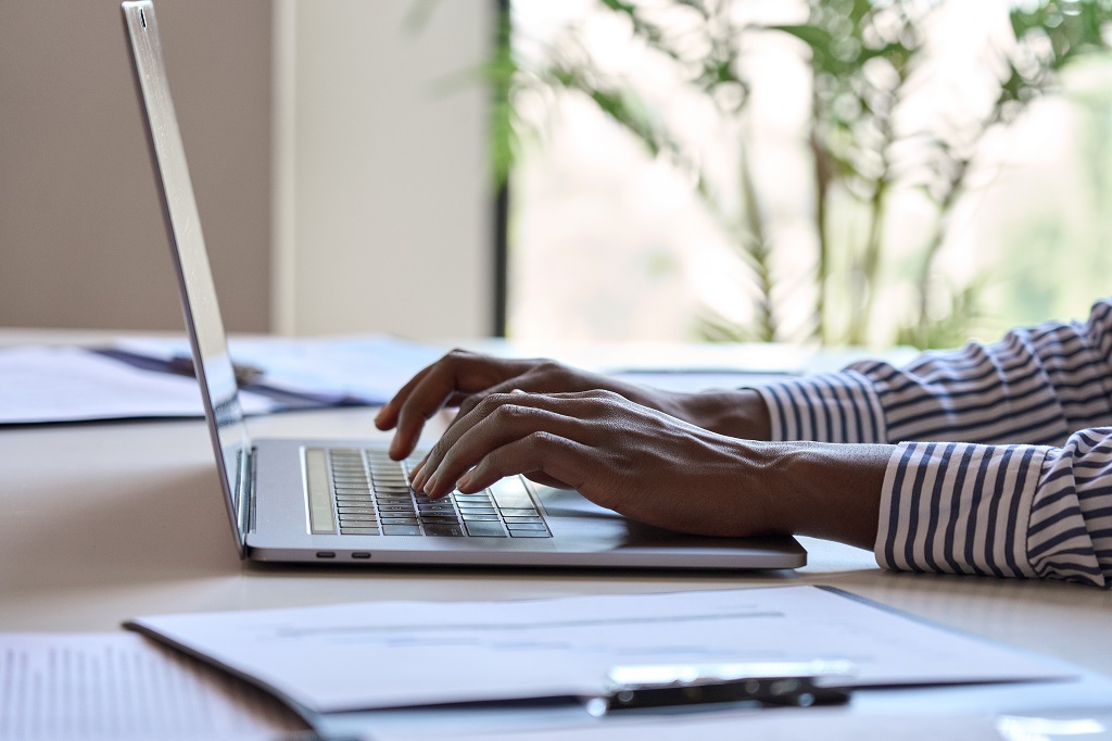 An Applicant Confidently Writing A Job Acceptance Letter With Full Knowledge On How To Accept A Job Offer