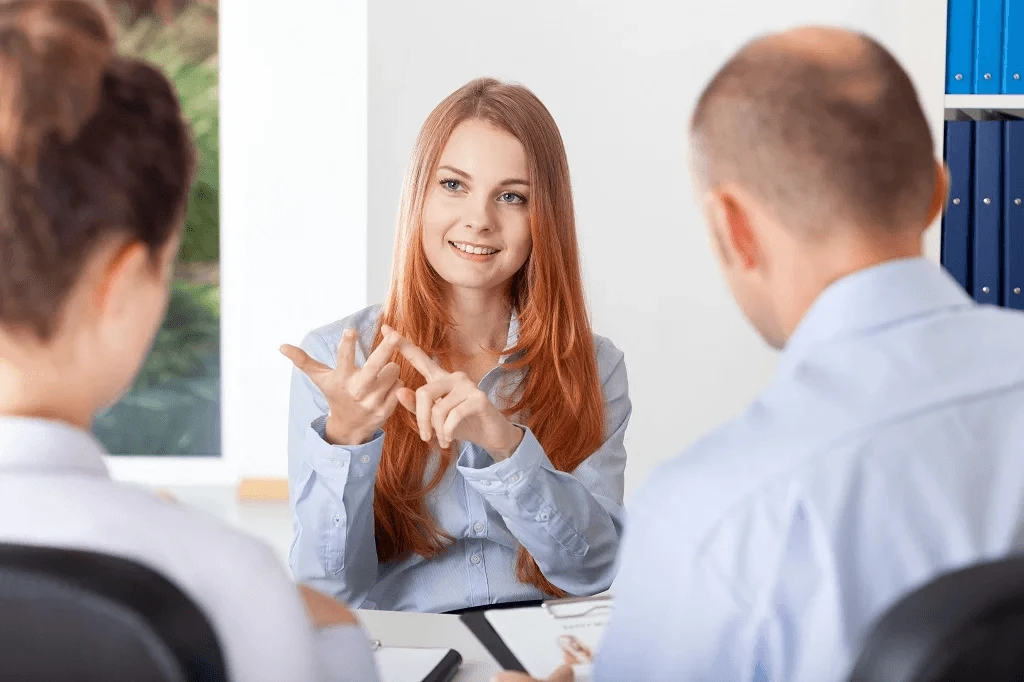 female job seeker asking questions to a panel of interviewers