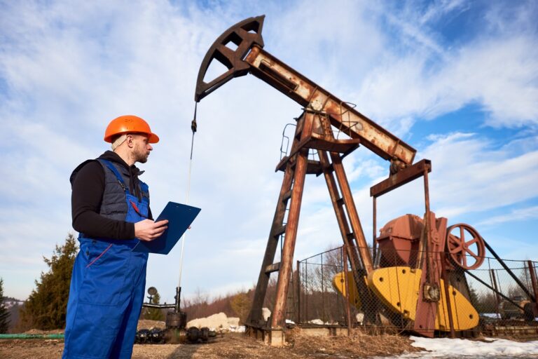 engineer inspecting the oil pump jack for optimal performance