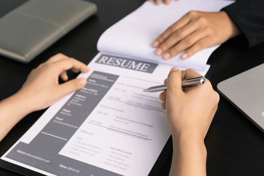 Employer Checking The Sections Of A Human Resources Resume
