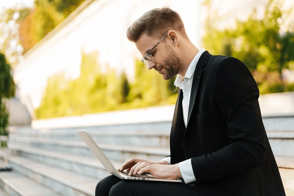 applicant constructing his job acceptance letter using a laptop