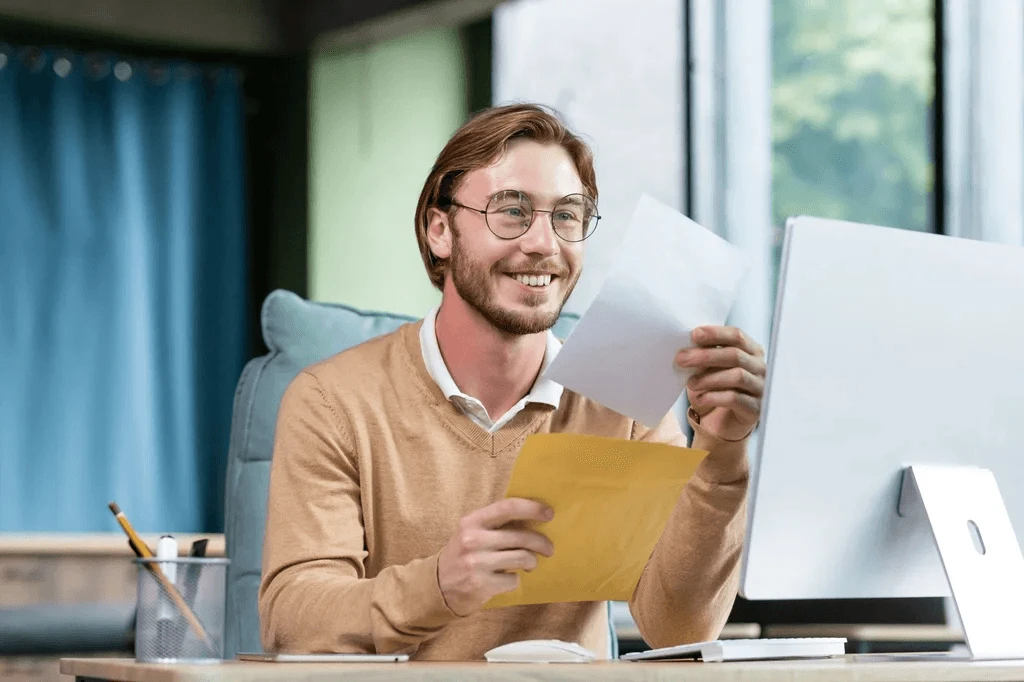 smiling hiring manager reading a job acceptance letter