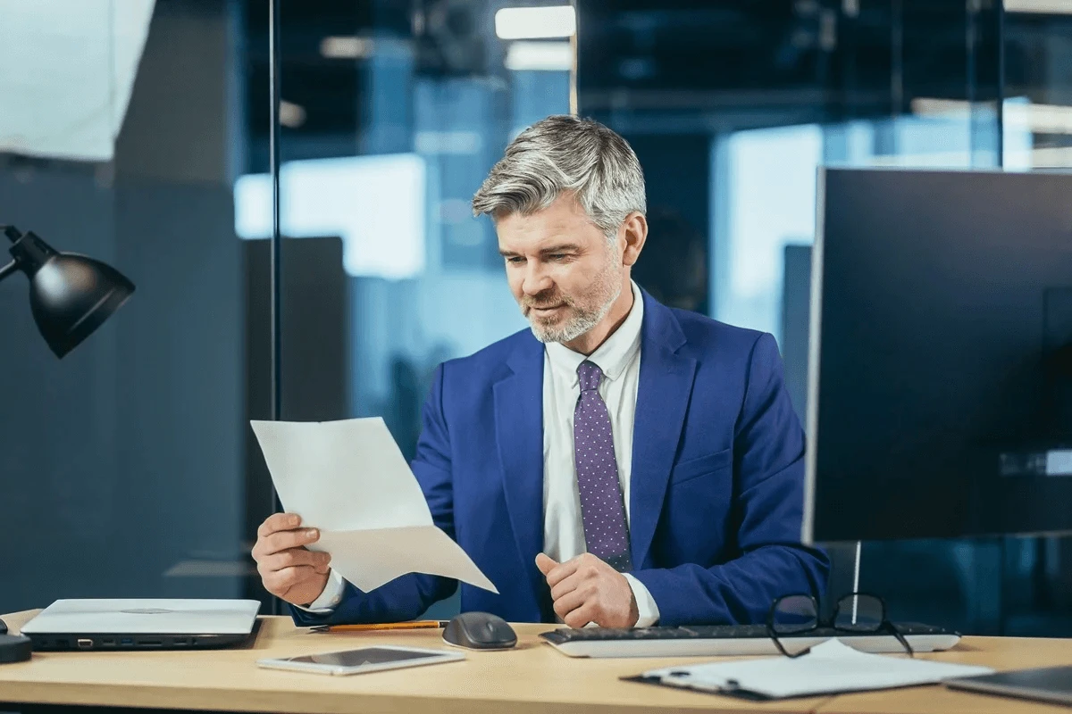 manager reading an excuse letter for work from an absent employee