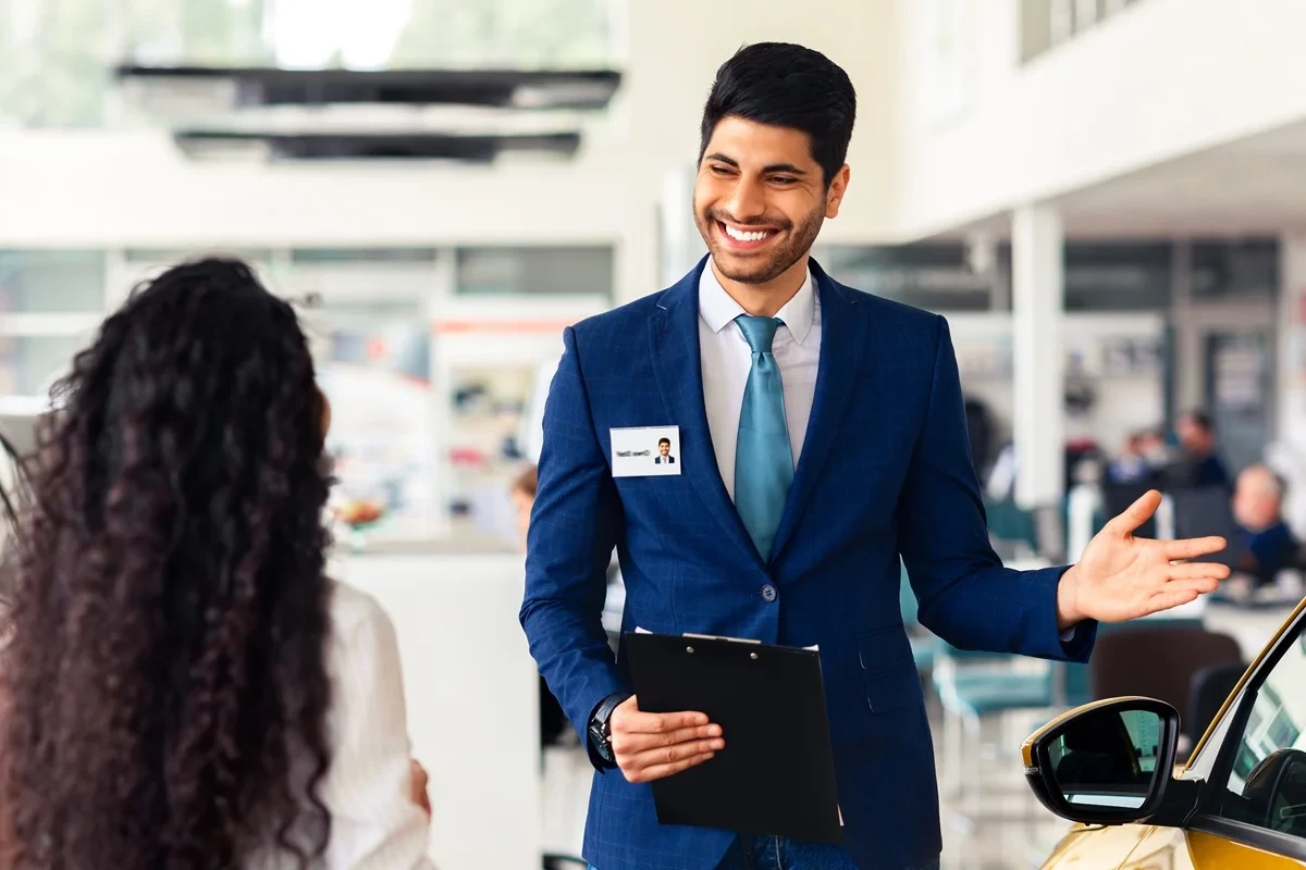 sales associate assisting a customer choosing a car