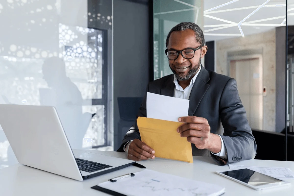 hiring manager reading a printed cover letter from an applicant