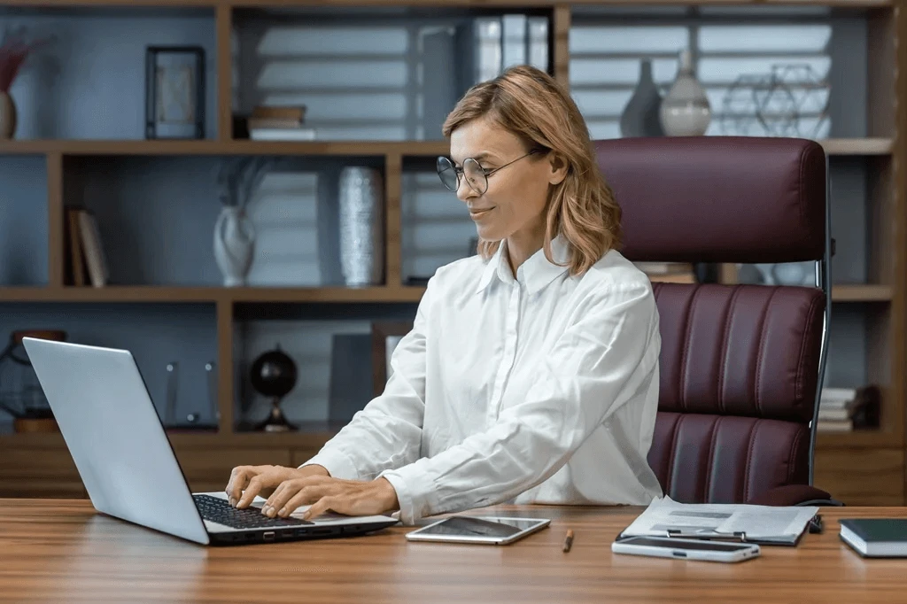 Chief Of Staff Optimizing Her Resume Using A Laptop