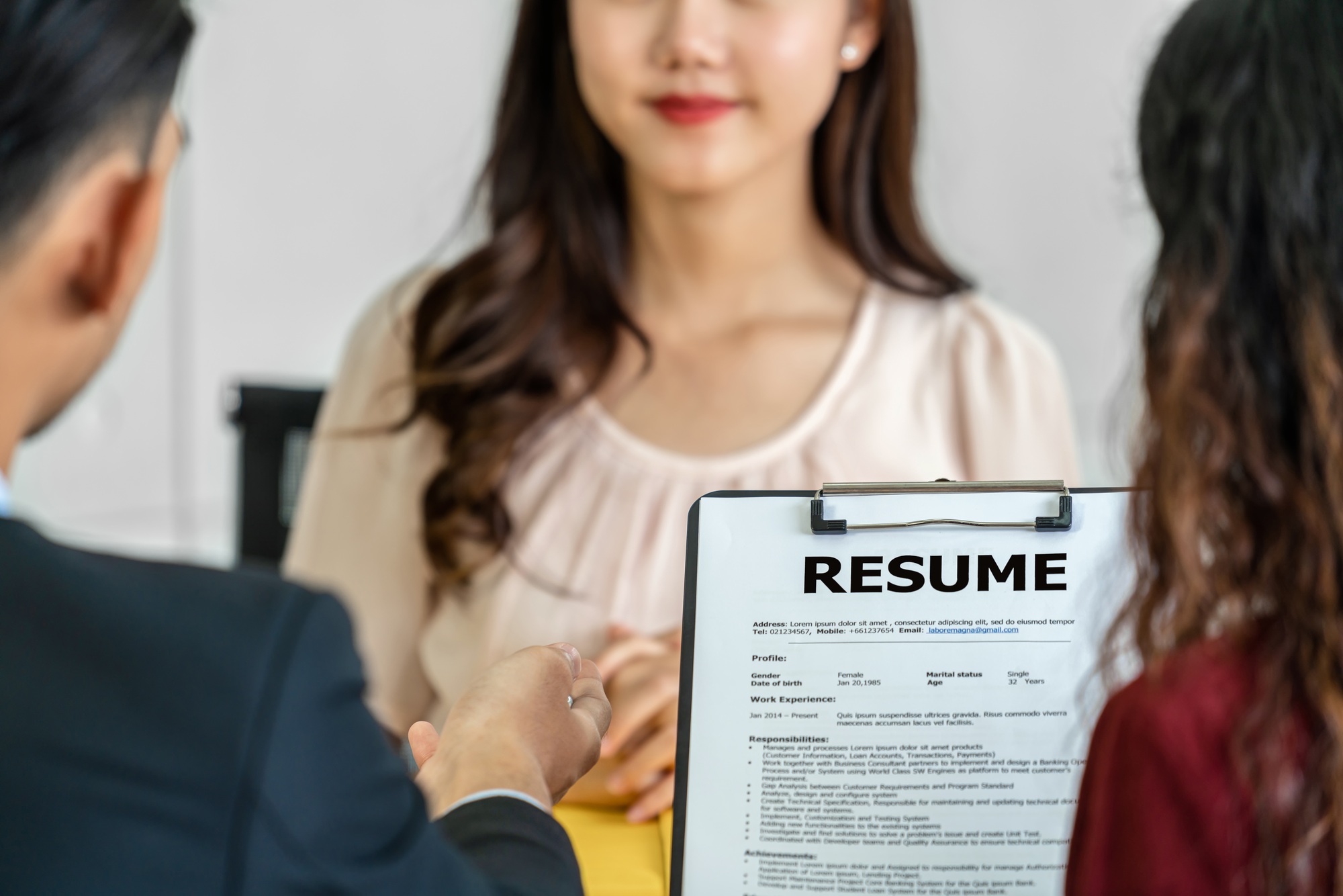 Closeup Resume in two manager hand holding when discuss about her resume
