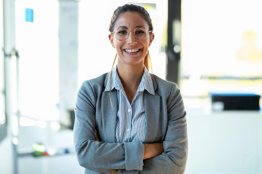 Confident Employee Standing With Arms Crossed