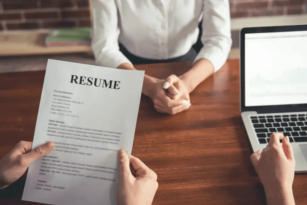 Employer Reading The Resume Profile Of A Job Applicant