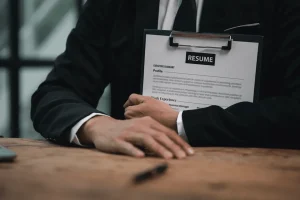 Hr Staff Holding A Resume Of An Applicant