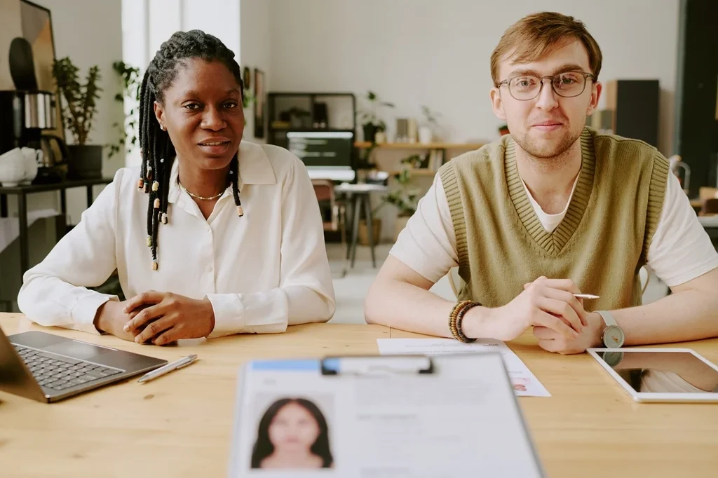 Job Applicant Handing Out Her Resume To Expert Resume Writers